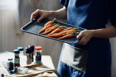 Midsection of man preparing food