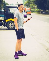 Full length of boy standing on road