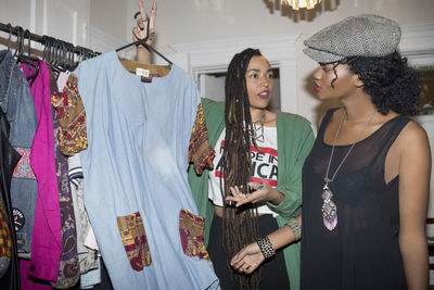Two young women choosing an outfit