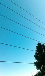 Low angle view of tree against clear blue sky