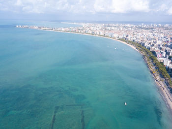 High angle view of sea and buildings against sky