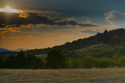 Scenic view of field against sky during sunset