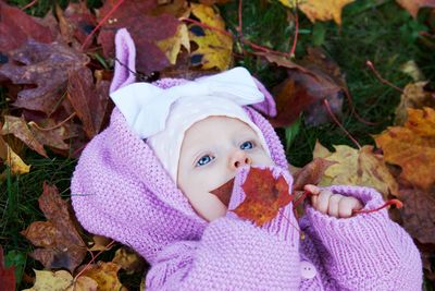 Portrait of a baby girl in autumn leaves