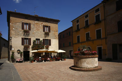 People on street by buildings in town