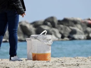 Low section of person standing on beach