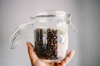 Close-up of hand holding glass jar