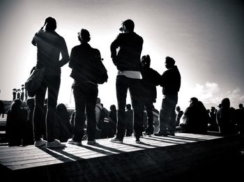 Rear view of a group of people against the sky