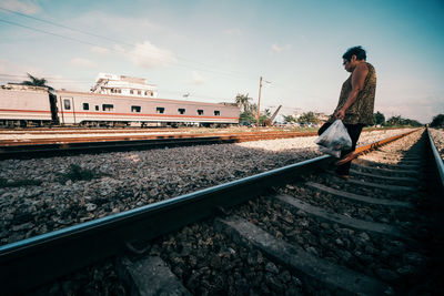 Full length of train at railroad station against sky