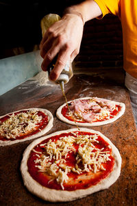 Midsection of man preparing food in restaurant