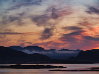 Scenic view of sea against romantic sky at sunset