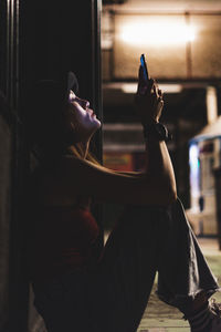 Side view of woman using mobile phone