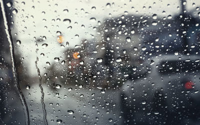 Full frame shot of wet glass window in rainy season