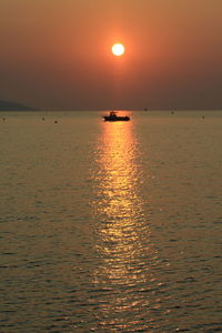 Scenic view of sea against romantic sky at sunset