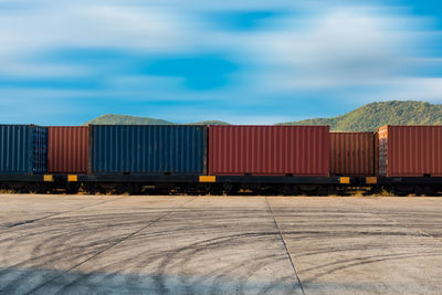 Close-up of freight train against cloudy sky