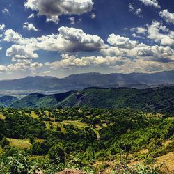 Scenic view of mountains against cloudy sky