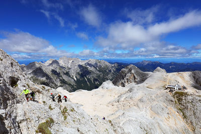 High angle view of hikers hiking on rocky mountain