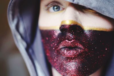 Close-up portrait of woman with painted face