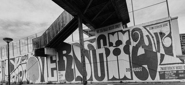 Low angle view of text on building against sky