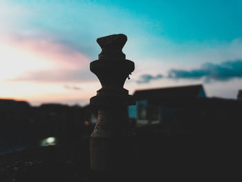 Close-up of silhouette chess against sky at sunset