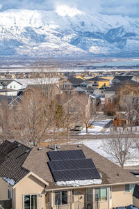 High angle view of townscape and snowcapped mountains