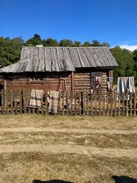 House on field against clear sky