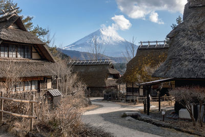 Houses and buildings against sky during winter