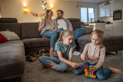 Children playing with daughter at home