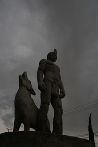 Low angle view of statue against sky