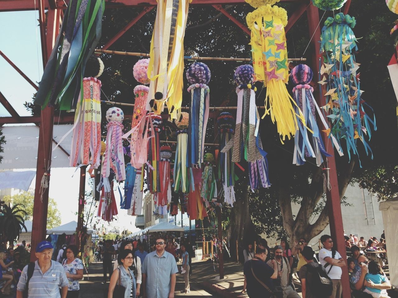 hanging, person, men, variation, large group of people, retail, multi colored, lifestyles, large group of objects, abundance, day, market, leisure activity, for sale, choice, outdoors, standing, in a row, shopping