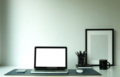 View of laptop arranged on desk at home