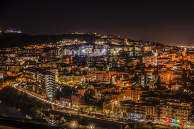 High angle view of illuminated buildings in city at night