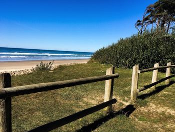 Scenic view of beach against blue sky