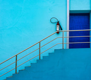 Low angle view of steps by swimming pool against building