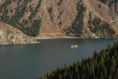 Scenic view of lake by trees against sky