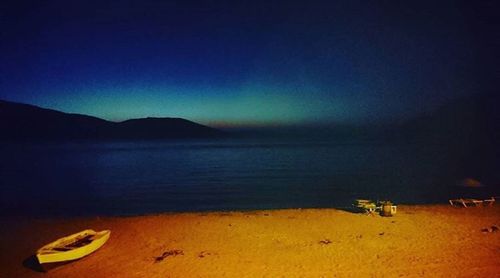 Scenic view of beach against sky at night