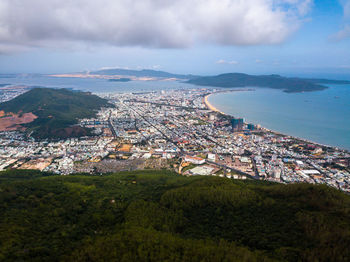 High angle view of townscape by sea against sky