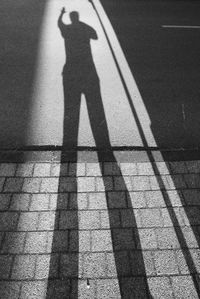 Shadow of man on tiled floor