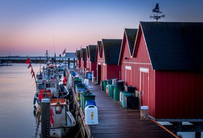 Huts on jetty against clear sky