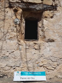 Low angle view of text on wall of old building