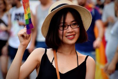 Portrait of smiling young woman wearing hat