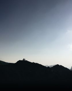 Silhouette mountain against clear sky