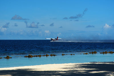 Scenic view of sea against cloudy sky