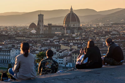 Rear view of people looking at cityscape