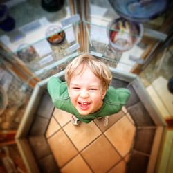 Portrait of happy boy standing on floor