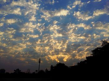 Low angle view of silhouette trees against sky during sunset