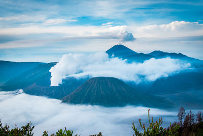 Scenic view of mountains against cloudy sky