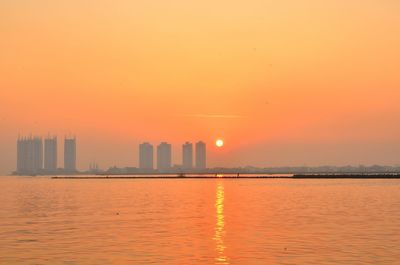 Scenic view of buildings against sky during sunset