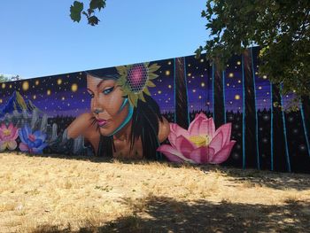 Woman with umbrella against sky