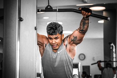 Muscular man exercising in gym