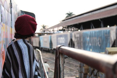 Rear view of woman standing against built structure